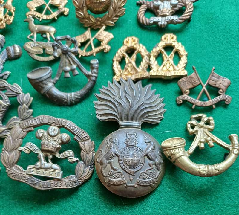 Selection of 16 military badges, sold as seen