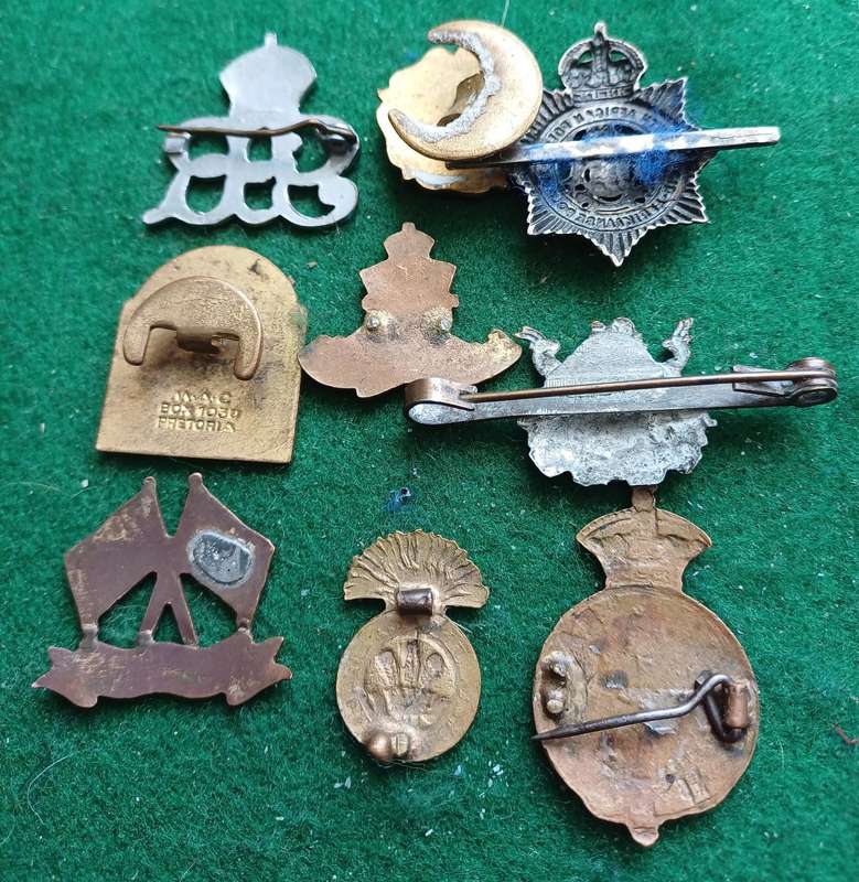 Lot of 9 Military badges mostly sweetheart.