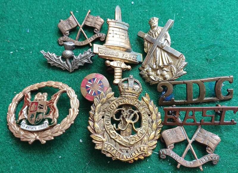 Selection of 10 military badges, sold as seen