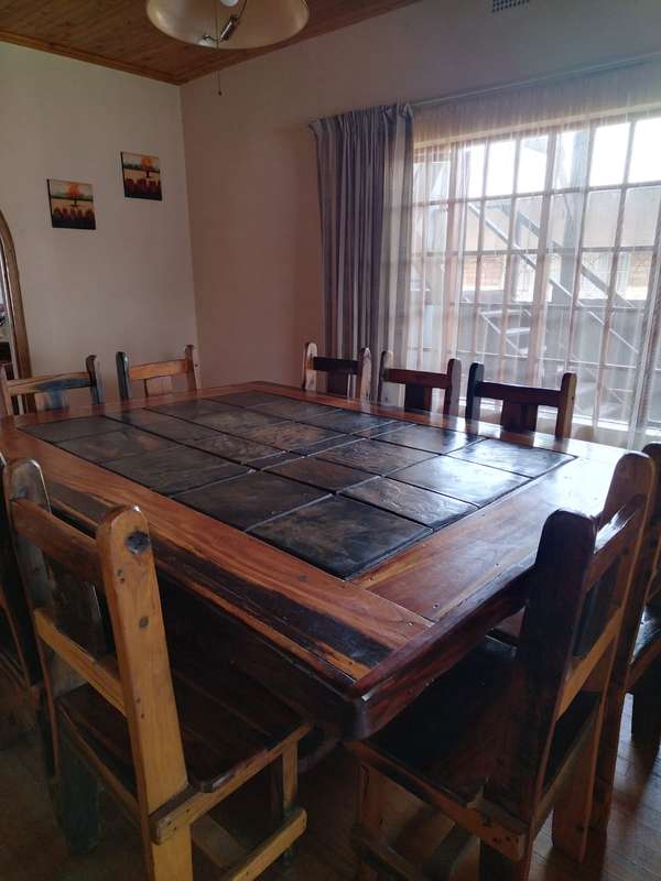 10 seater sleeper wood (Rhodesian teak) and slate dining room table & chairs in good condition