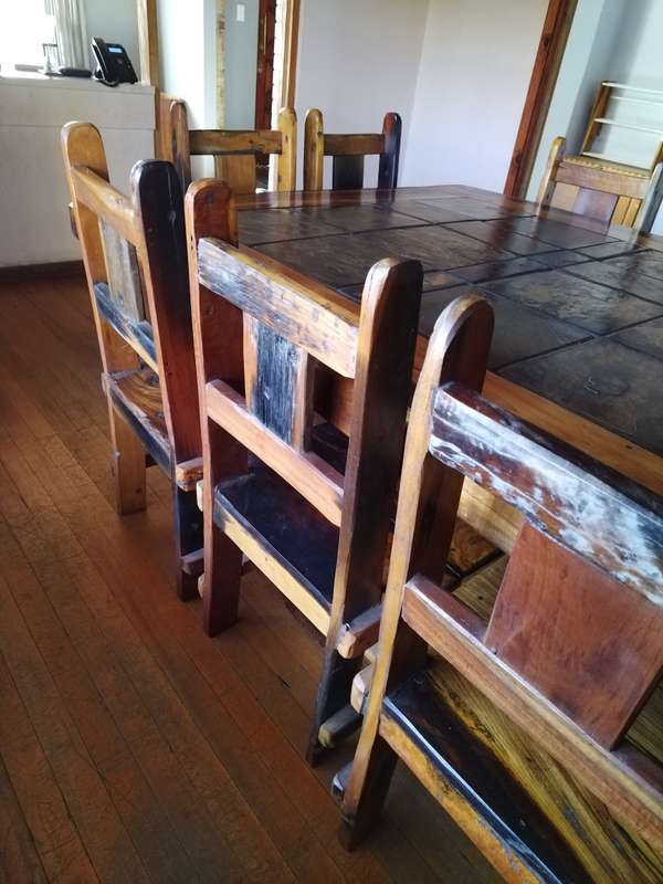 10 seater sleeper wood (Rhodesian teak) and slate dining room table & chairs in good condition