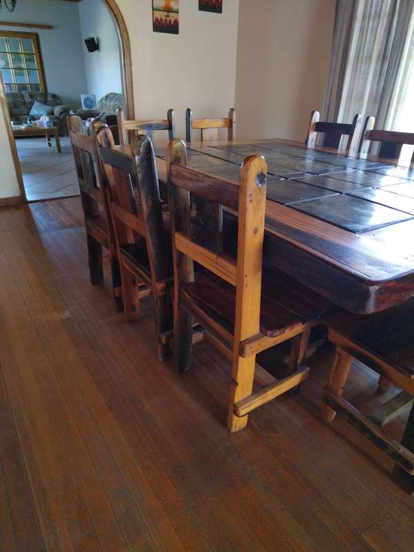 10 seater sleeper wood (Rhodesian teak) and slate dining room table & chairs in good condition