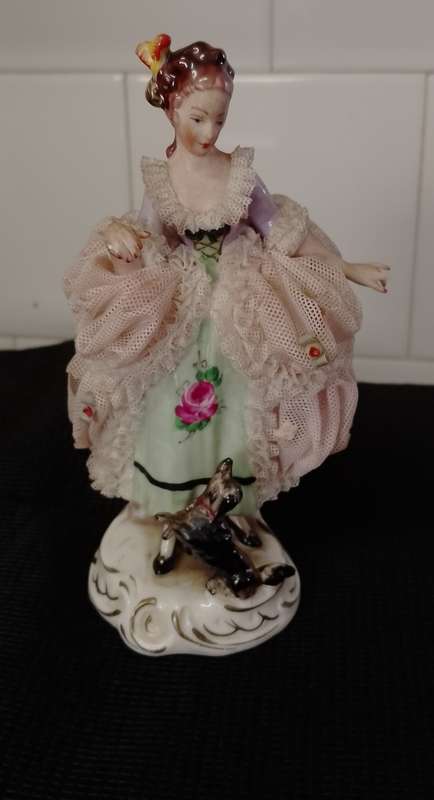 A VINTAGE DRESDEN FIGURINE with puppy. 16cm high base 6x6cm