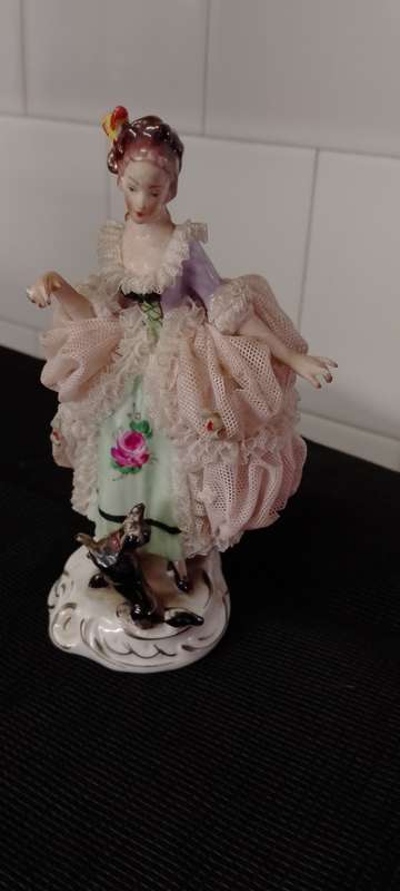 A VINTAGE DRESDEN FIGURINE with puppy. 16cm high base 6x6cm