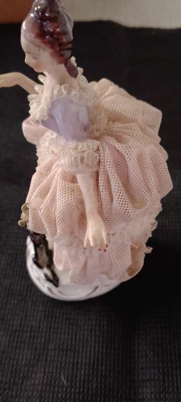 A VINTAGE DRESDEN FIGURINE with puppy. 16cm high base 6x6cm