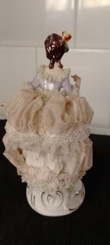 A VINTAGE DRESDEN FIGURINE with puppy. 16cm high base 6x6cm