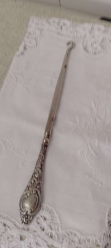 An antique silver handled corset hook 20cm long