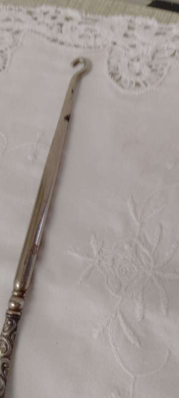 An antique silver handled corset hook 20cm long