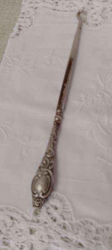 An antique silver handled corset hook 20cm long