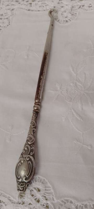 An antique silver handled corset hook 20cm long