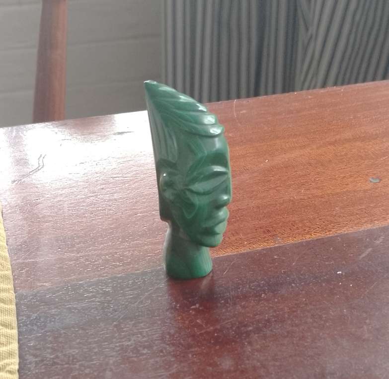 A Malachite "talking head" 7cm tall base 1.5cm across