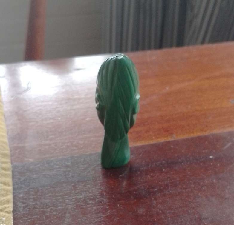 A Malachite "talking head" 7cm tall base 1.5cm across