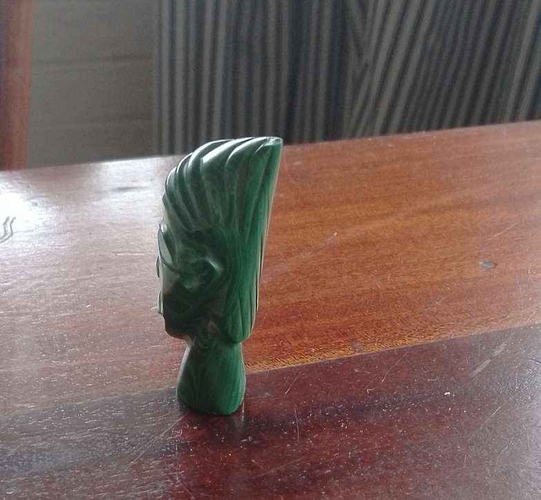 A Malachite "talking head" 7cm tall base 1.5cm across