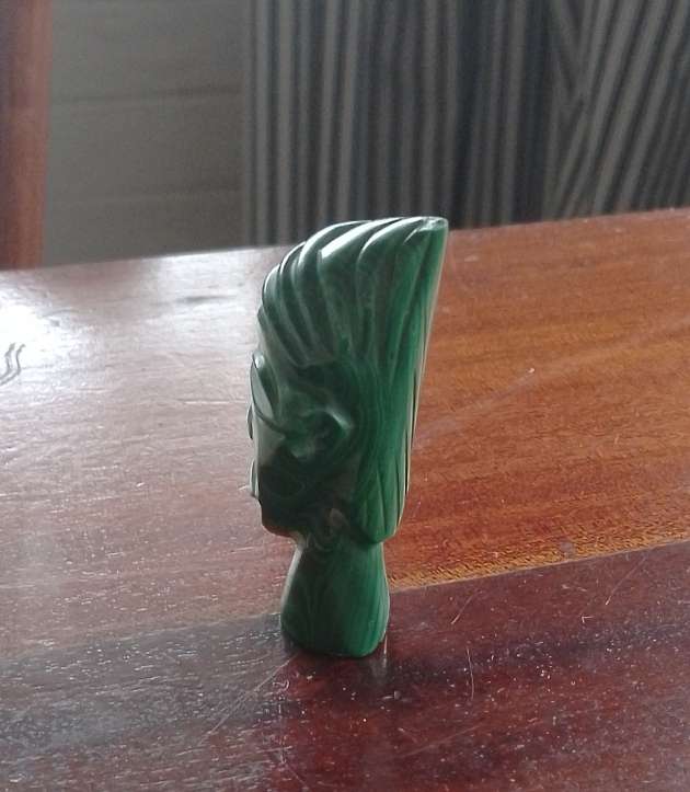 A Malachite "talking head" 7cm tall base 1.5cm across