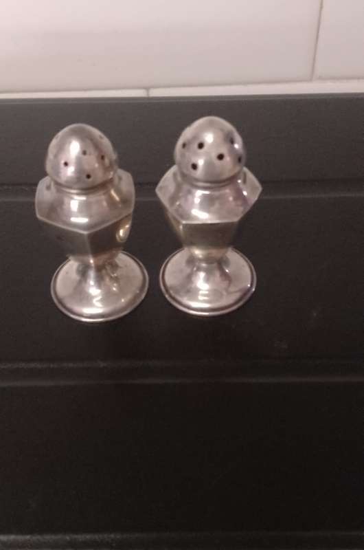 A pair of Sterling salt and pepper shakers 5cm tall base 2.5cm