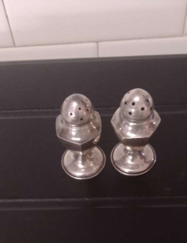 A pair of Sterling salt and pepper shakers 5cm tall base 2.5cm