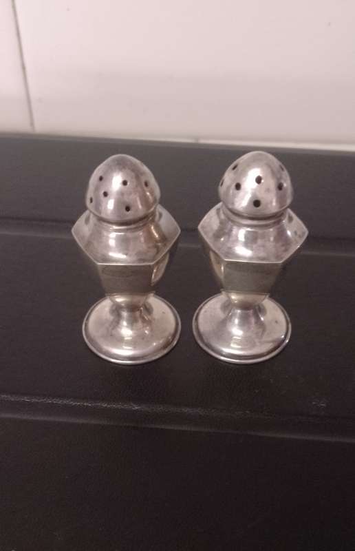 A pair of Sterling salt and pepper shakers 5cm tall base 2.5cm