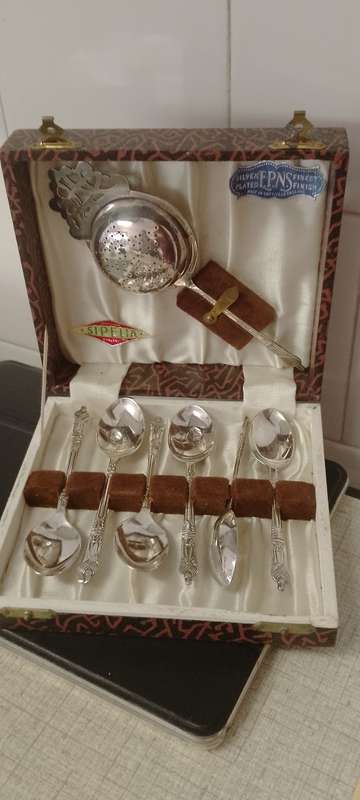 A EPNS vintage apostle tea spoons and tea strainer.