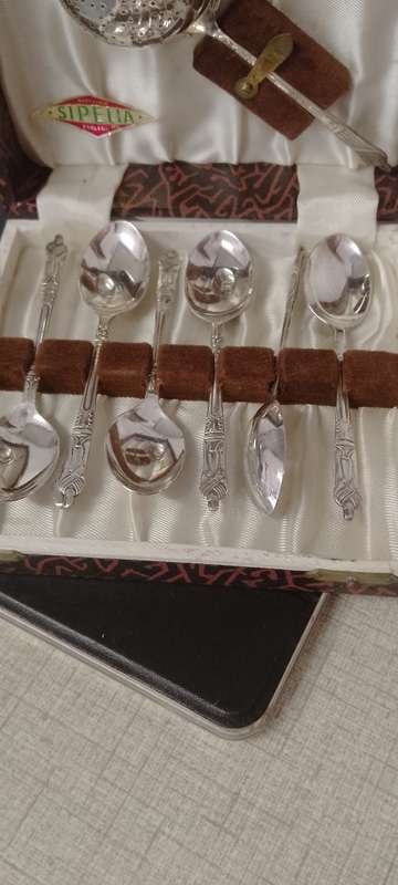 A EPNS vintage apostle tea spoons and tea strainer.