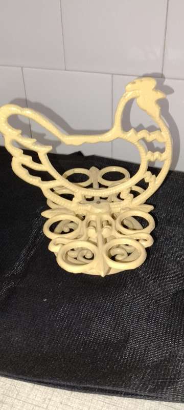 A heavy cast iron -chicken egg holder