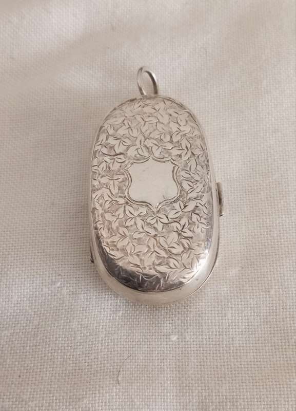 A sterling engraved sovereign case pendant