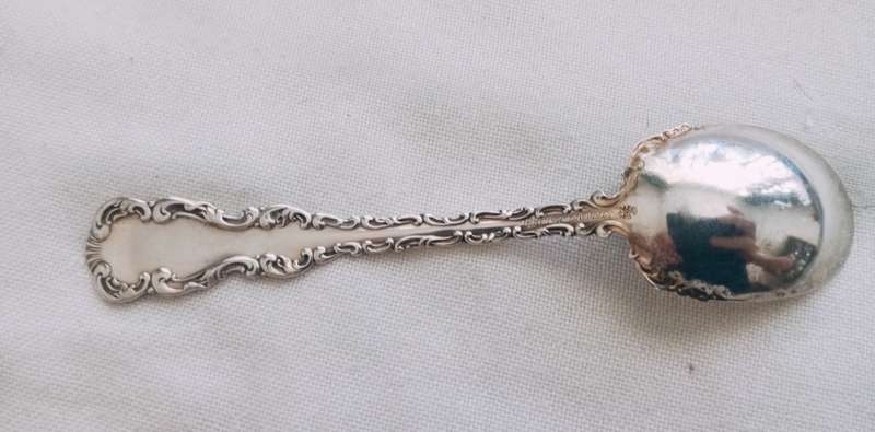 A sterling silver ornate sugar spoon