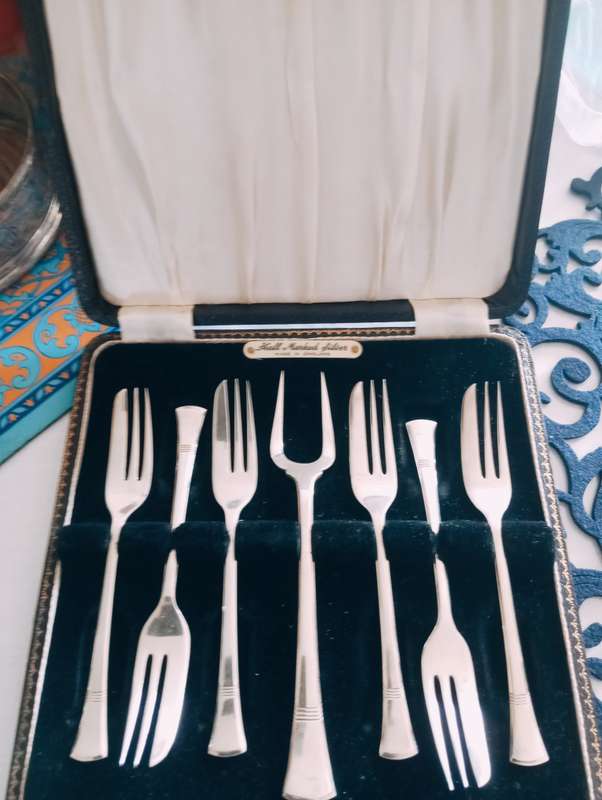 A fine boxed  set of sterling silver  cake forks