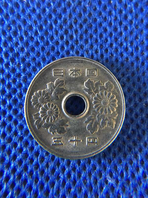 JAPAN 50 YEN COIN WITH HOLE IN CENTRE - EDGE RIDGES ON COIN