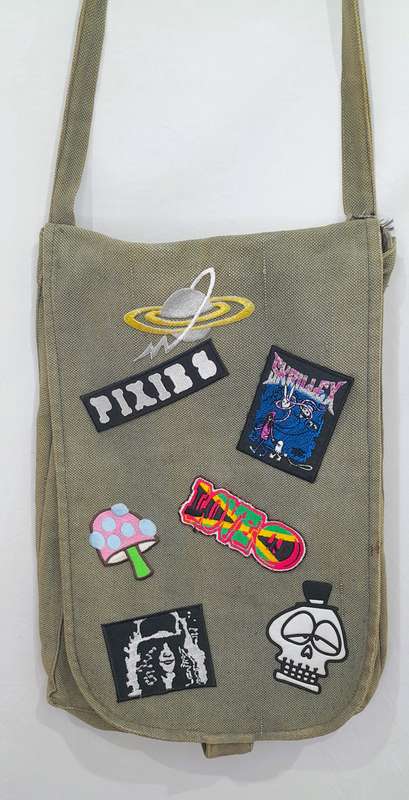 Vintage army sling bag with badge and patch detailing