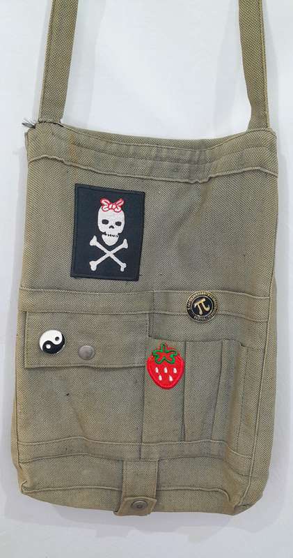 Vintage army sling bag with badge and patch detailing