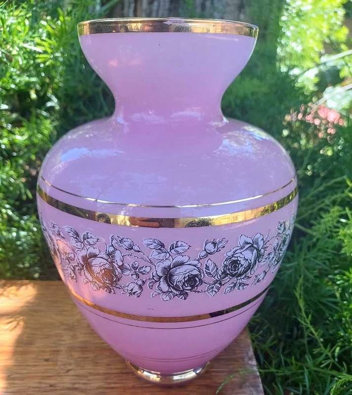 Beautiful pink glass vase with gold trim.