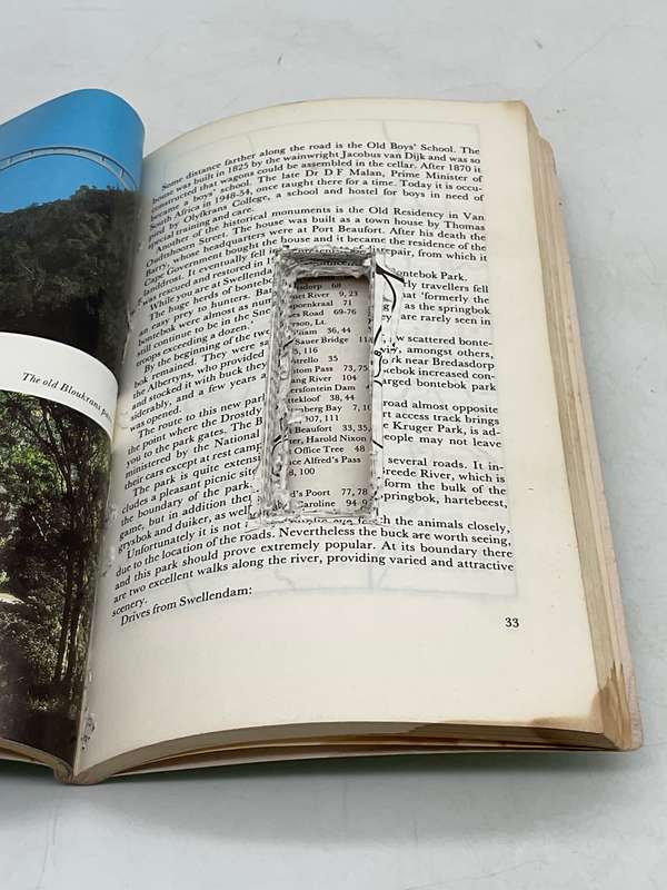 Book with pages cut to make a small hidden compartment