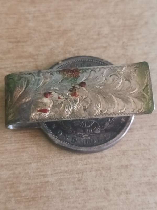 1883 Morgan Dollar with note clasp attached. 42.3gr 90% silver