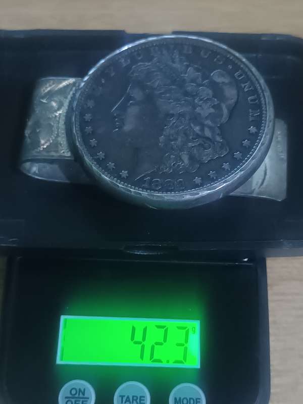 1883 Morgan Dollar with note clasp attached. 42.3gr 90% silver