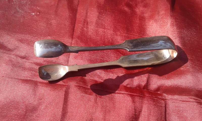 Silver-plated sugar tongs.