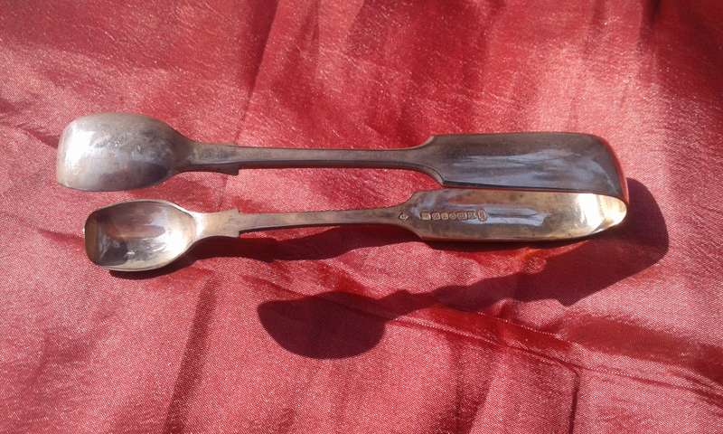 Silver-plated sugar tongs.