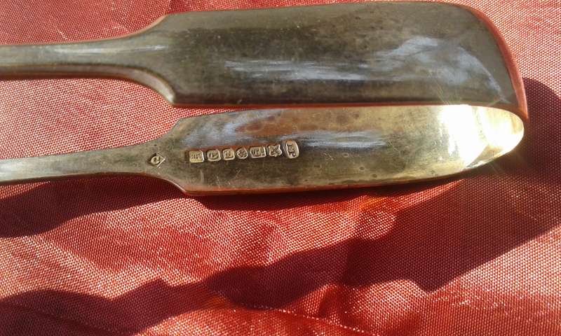 Silver-plated sugar tongs.