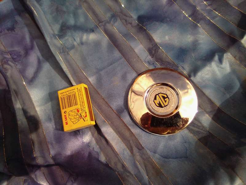 Small, MG automobile, metal disc.