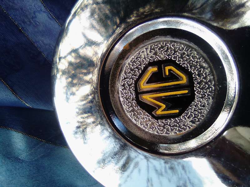 Small, MG automobile, metal disc.
