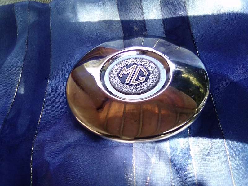 Small, MG automobile, metal disc.