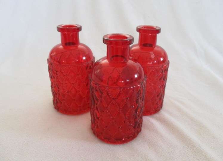 Three pretty red glass bottles (please disregard reflections)