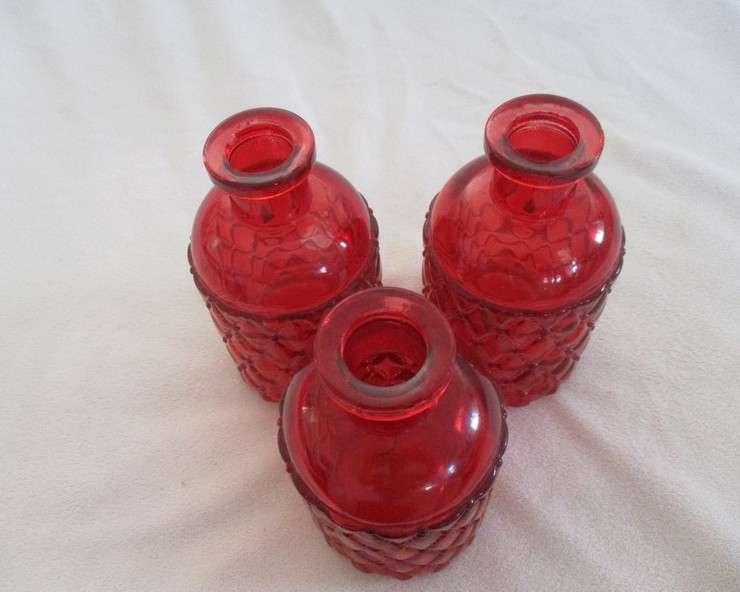 Three pretty red glass bottles (please disregard reflections)