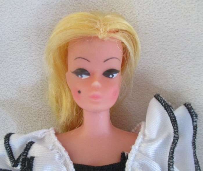 A vintage Barbie clone doll with ""cat eye" make up and beauty spot - made in Hong Kong