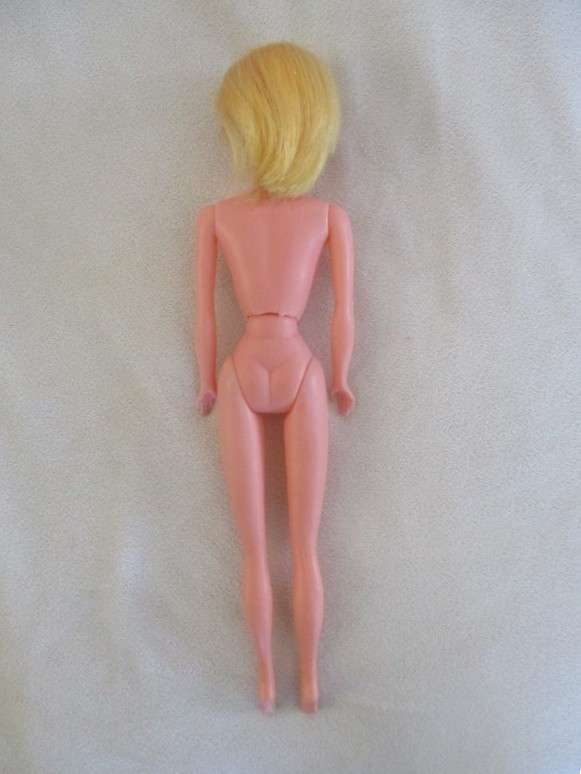 A vintage Barbie clone doll with ""cat eye" make up and beauty spot - made in Hong Kong