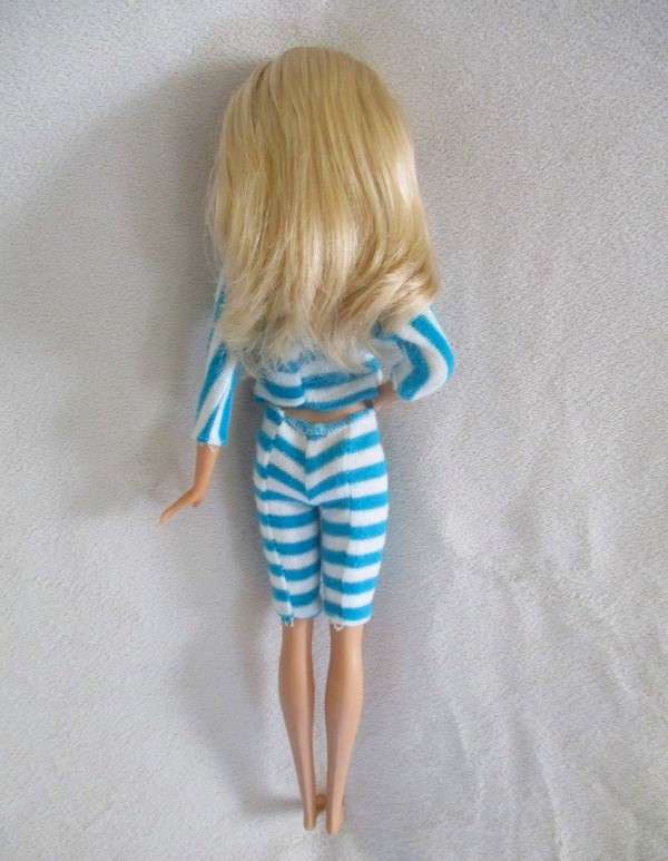 A pretty Mattel Barbie doll  in cute striped tracksuit