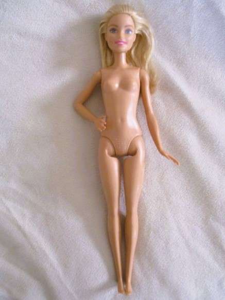 A pretty Mattel Barbie doll  in cute striped tracksuit