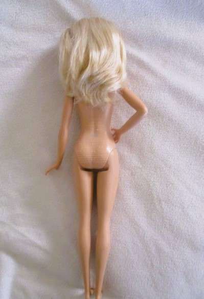 A pretty Mattel Barbie doll  in cute striped tracksuit