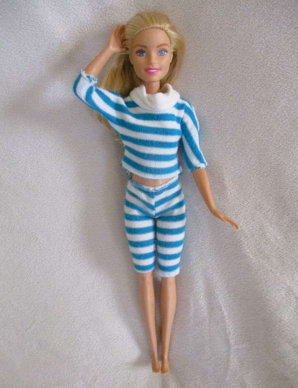 A pretty Mattel Barbie doll  in cute striped tracksuit