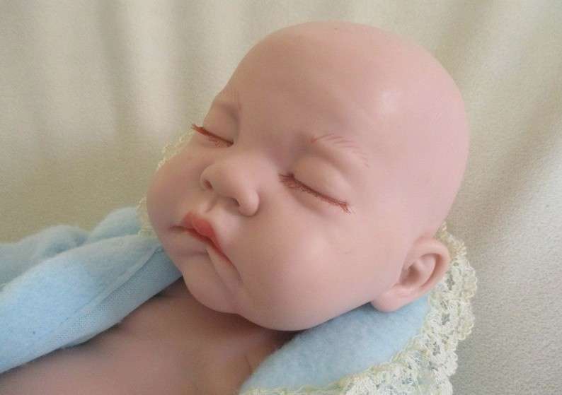 Reborn doll? Have you ever seen such a cute face?  Vinyl not porcelain