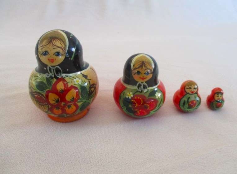 Four piece set of vintage genuine Russian wooden hand painted Matryoshka nesting dolls